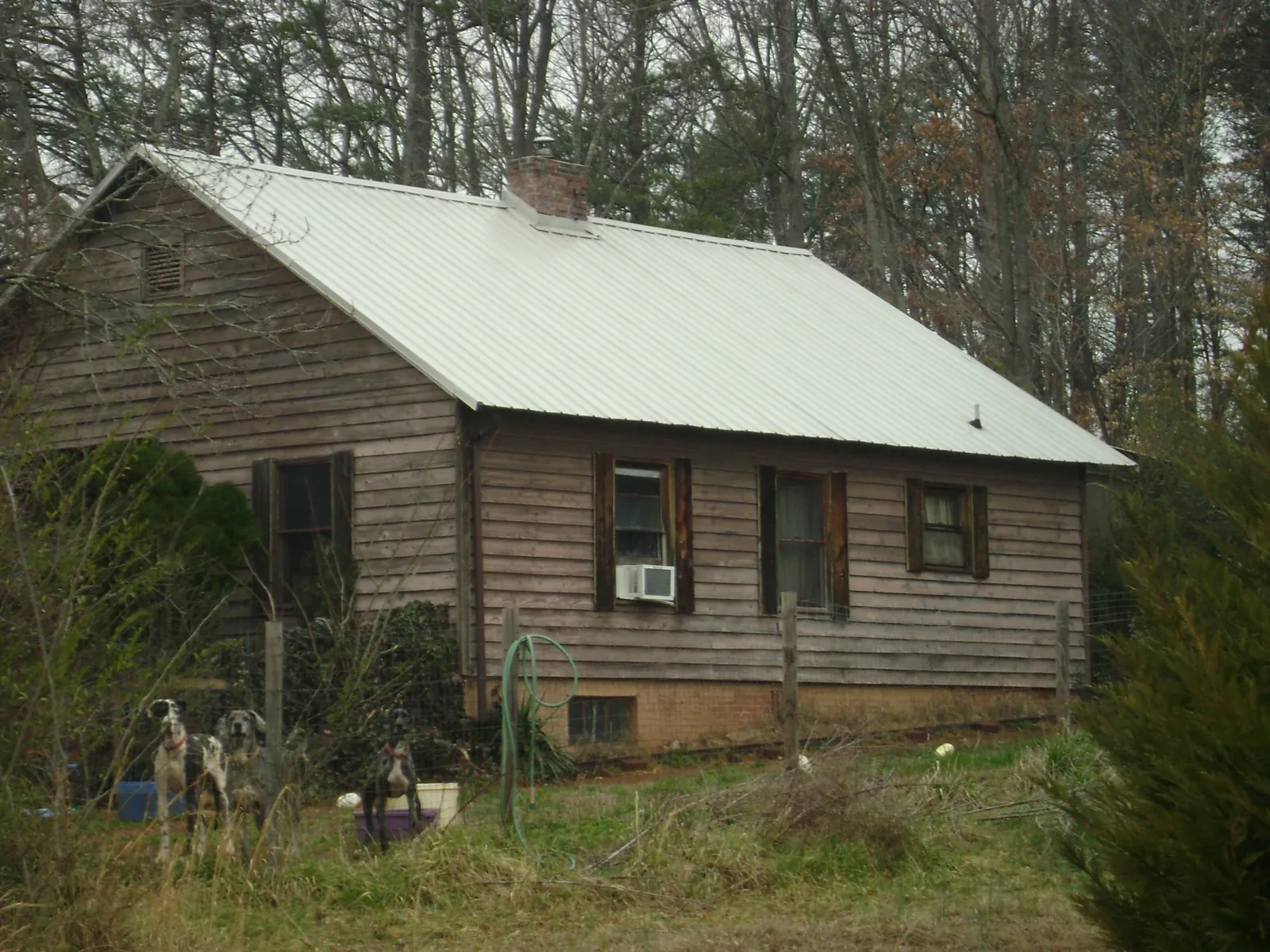 White metal roof on an old wood sided farmhouse, from a Metal Roof Installation job in Saint Louis
